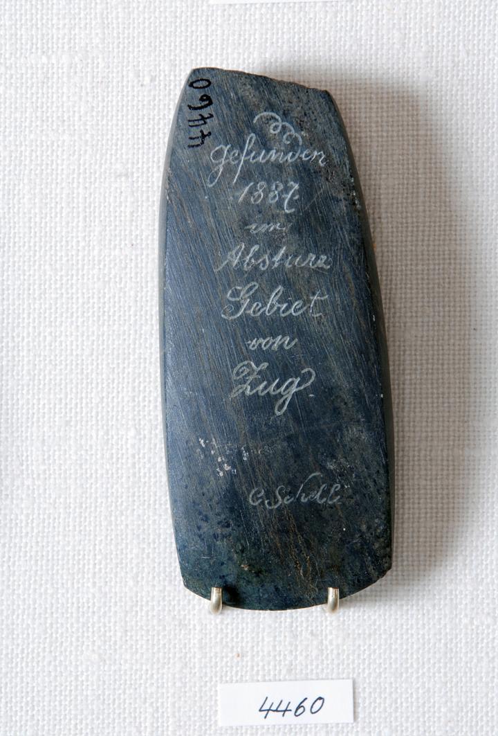<p>Jungsteinzeitliches Steinbeil, das nach der Vorstadtkatastrophe von 1887 zum Vorschein kam. Der Finder Carl Schell hat diese Information in das Beil graviert.</p>